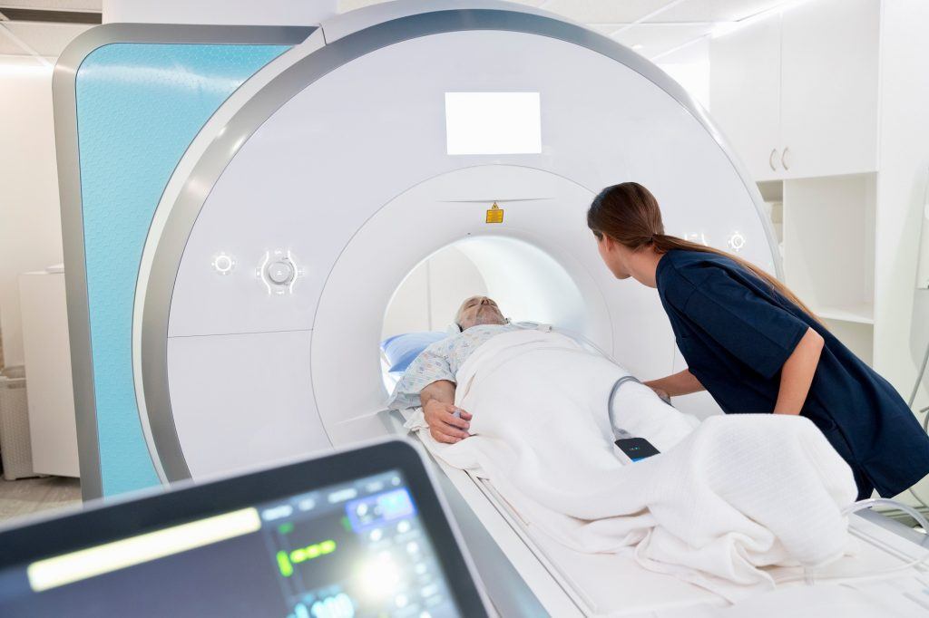 Nurse caring for a patient undergoing an MRI scan