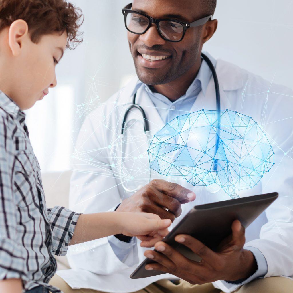 Arzt zeigt einem Kind am Tablet ein Gehirn