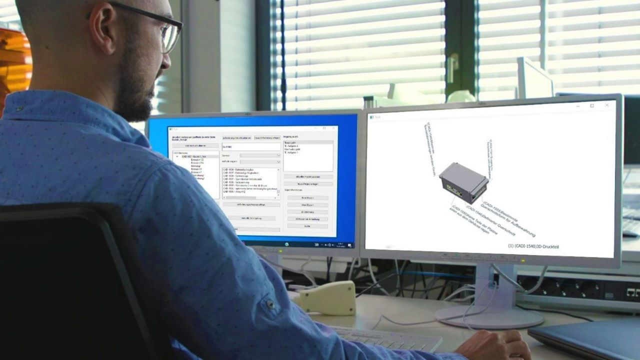 ITK's mechanical engineer looks at two screens showing a design in the CAD program and the associated design requirements.