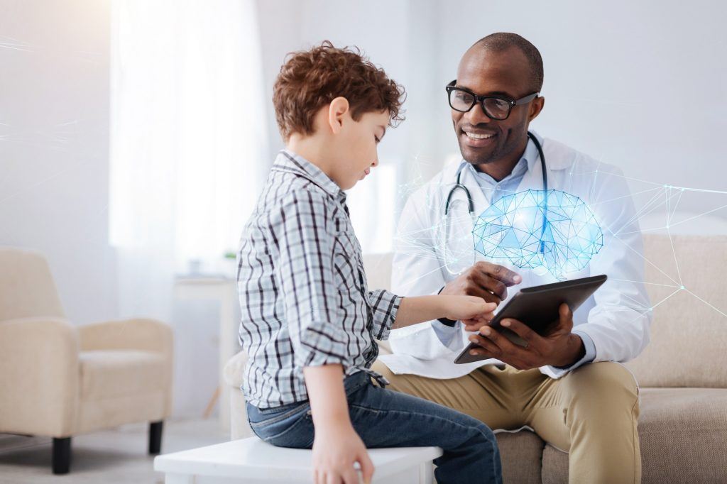 Doctor shows Boy something on a tablet