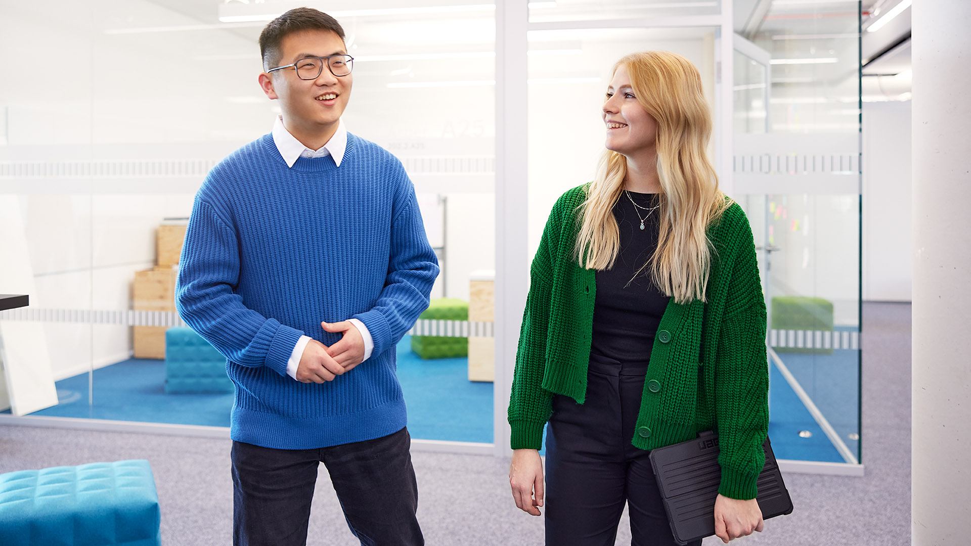 Two young ITK employees talking in Open Space
