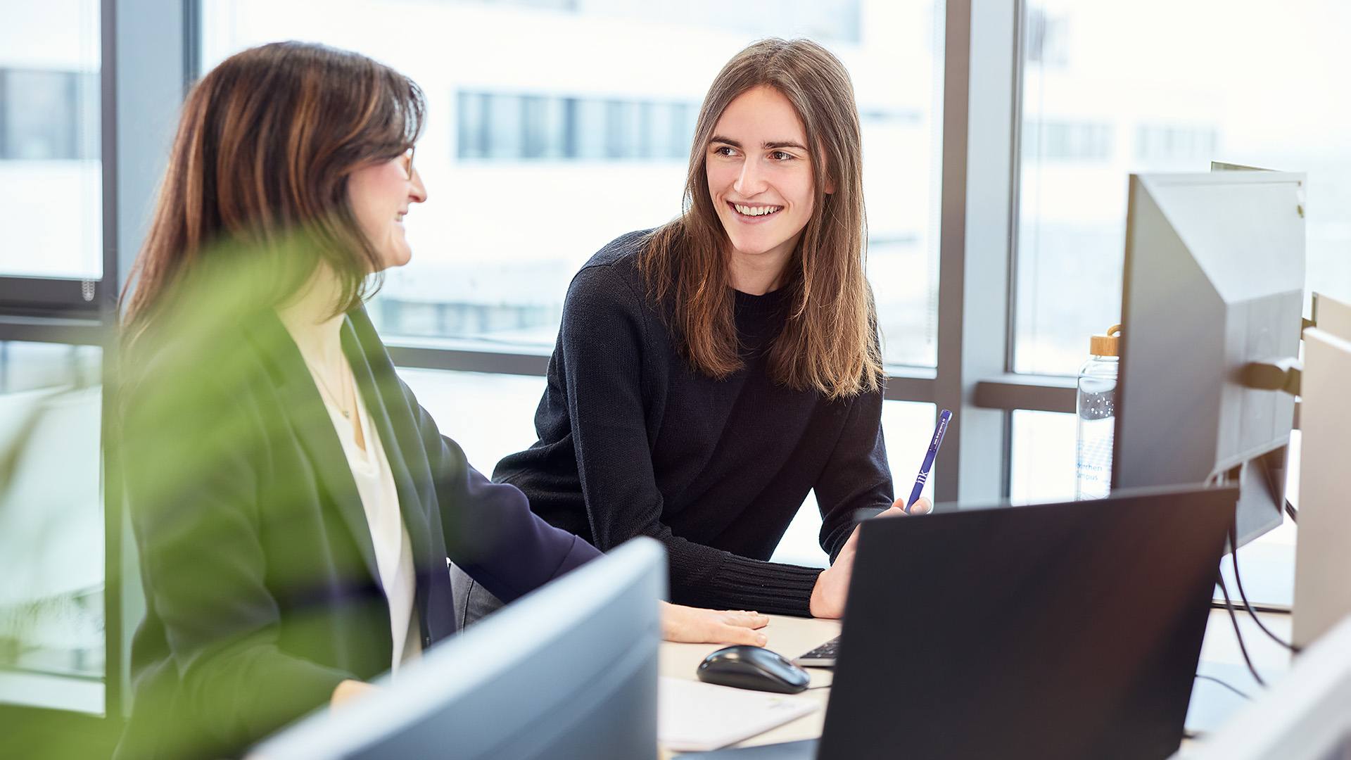 An ITK student and her tutor at work