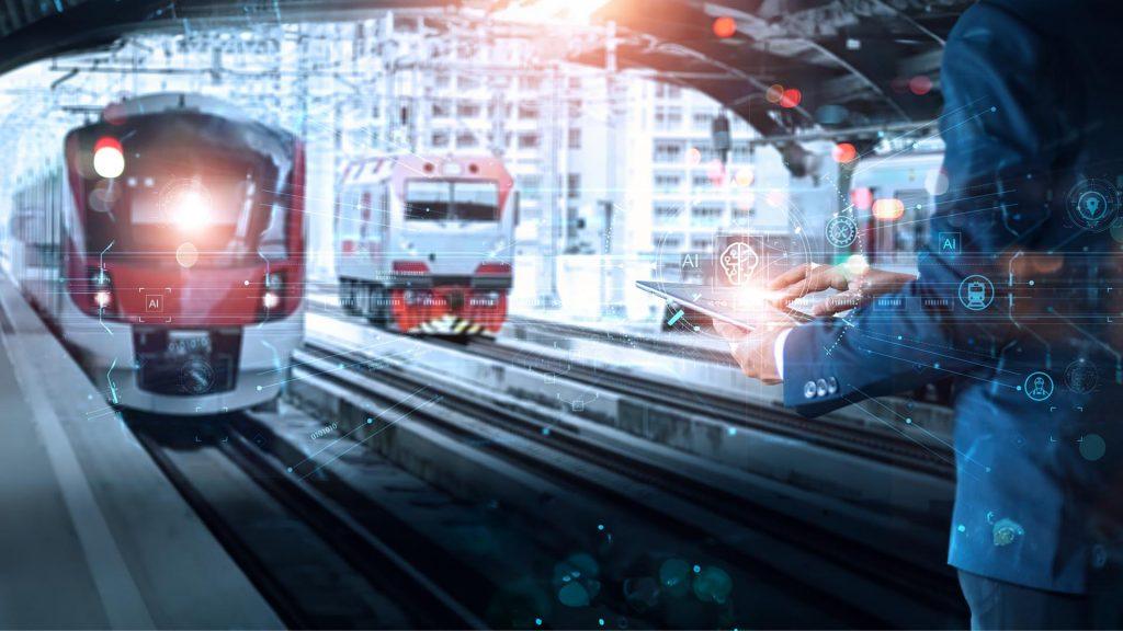 A train pulling into the station with a person on a tablet checking the train's software