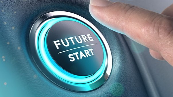 Finger pressing the start button of a car with the inscription “Future / Start.”