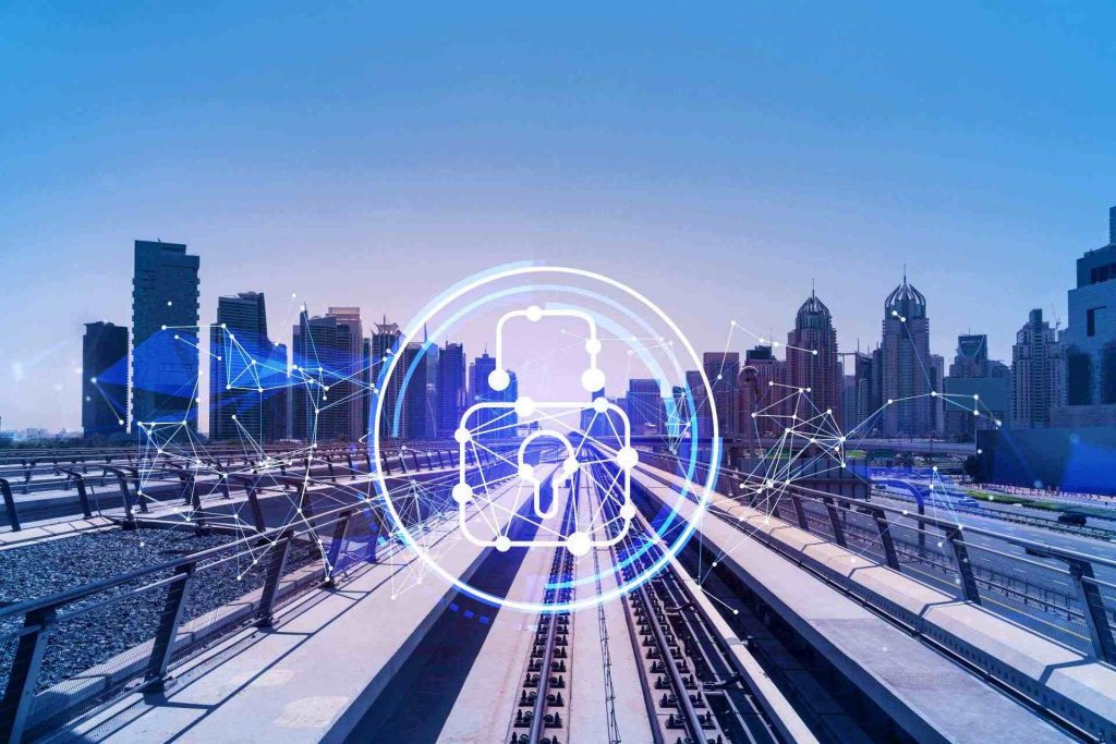 Railroad tracks with skyline in the background and cybersecurity lock symbol in the foreground.