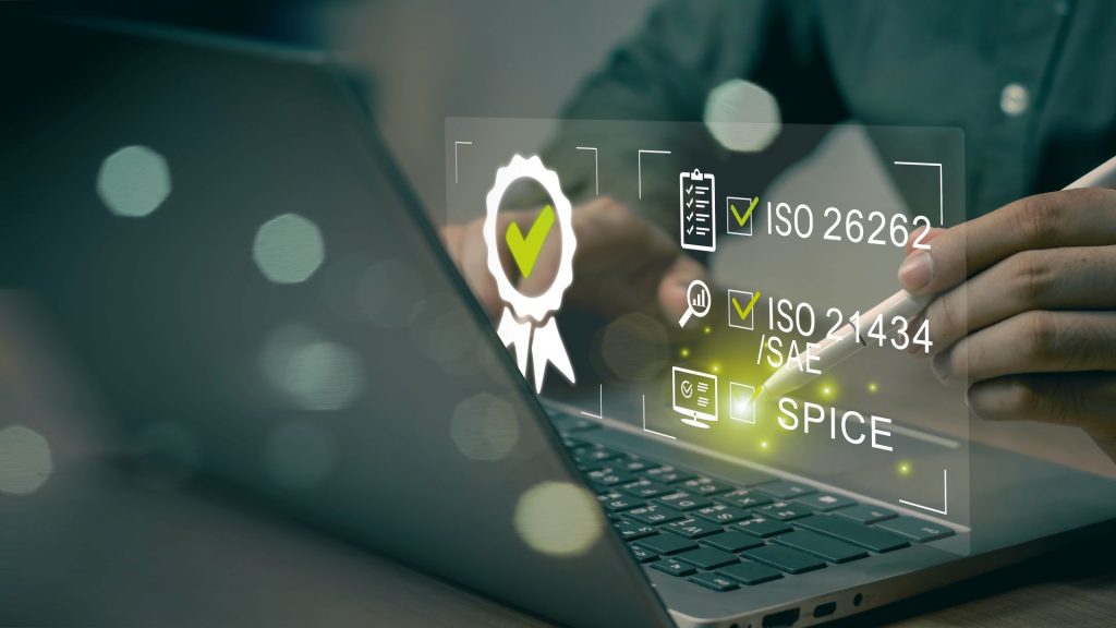 Training participant using a laptop and pen during a training course on functional safety in the automotive sector.