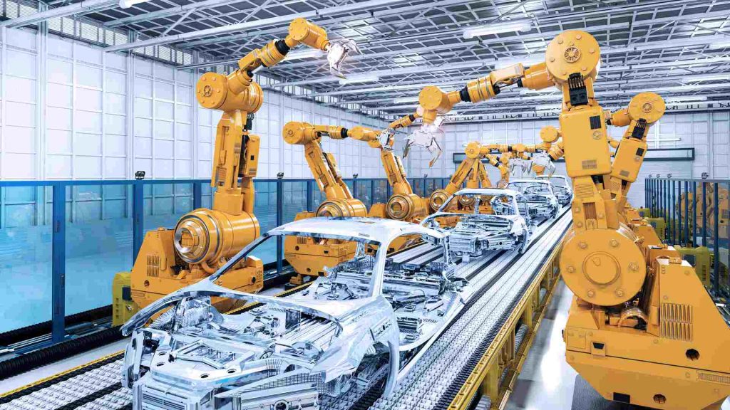 Robots assemble cars on an assembly line in a modern manufacturing plant.