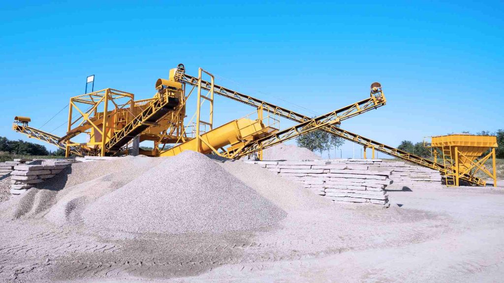 A massive concrete crusher breaks down material for sand production.