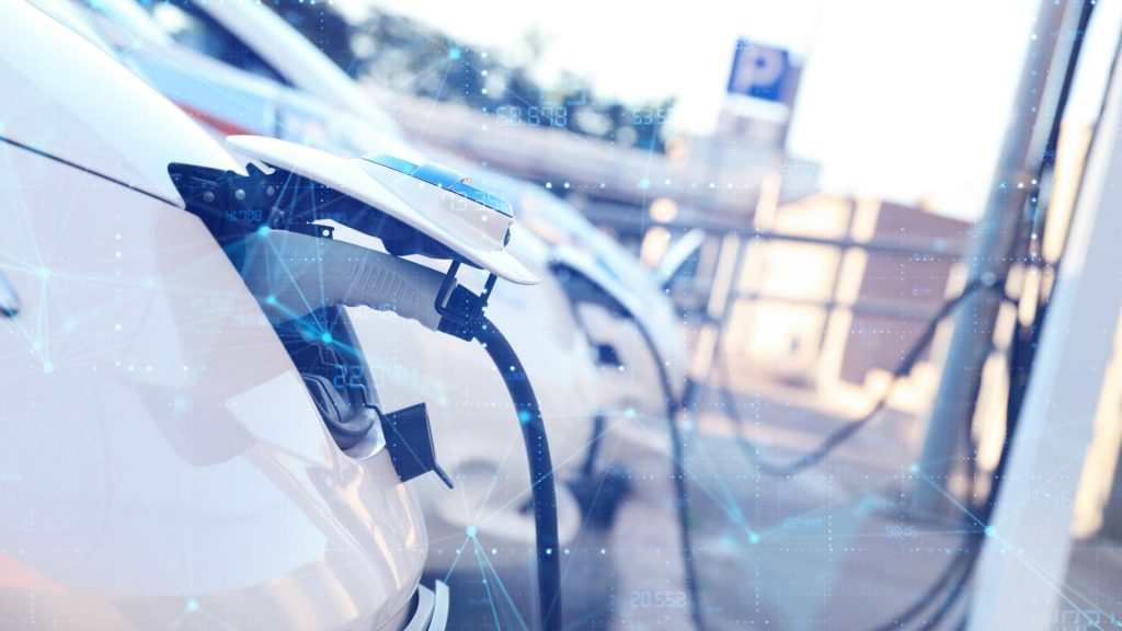 An electric vehicle at a charging station with digital connectivity and data communication, symbolizing smart electric mobility and modern charging infrastructure.
