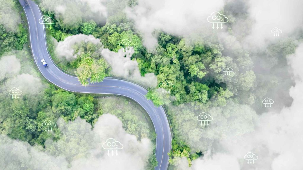 Aerial view of a street featuring visualized CO₂ reduction symbols, illustrating ITK Engineering's contribution to decarbonization through smart software solutions for zero-emission mobility and sustainable infrastructure.